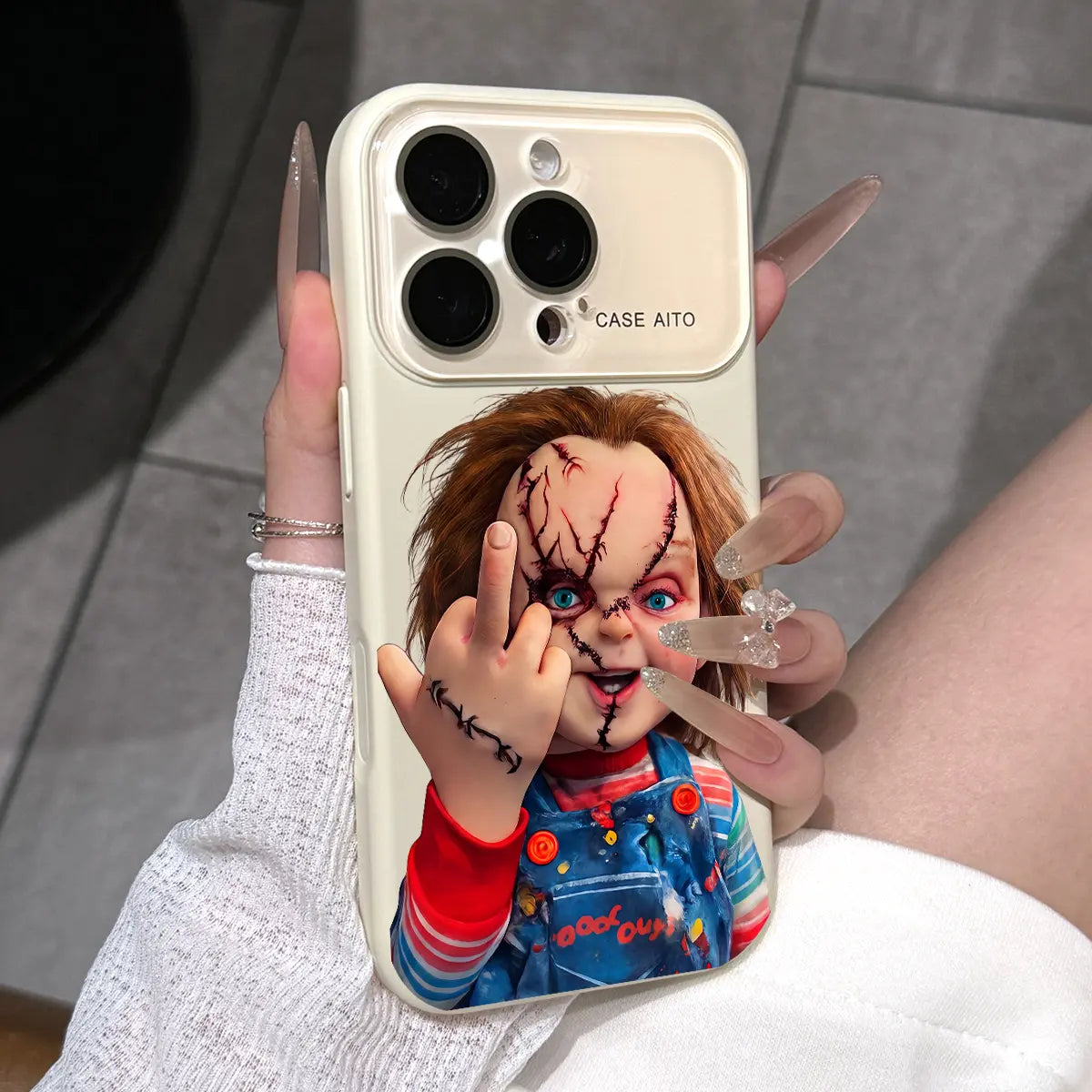 Chucky Creepy Gesture Pattern Dopamine Ins Style Solid Color Phone Case with Ultra Skin friendly Touch, All Inclusive Lens Phone Case Suitable for iPhone 17 16 15 14 13 12 Pro Max Air