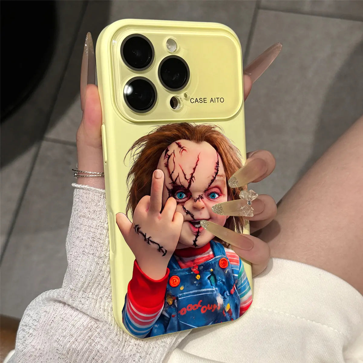 Chucky Creepy Gesture Pattern Dopamine Ins Style Solid Color Phone Case with Ultra Skin friendly Touch, All Inclusive Lens Phone Case Suitable for iPhone 17 16 15 14 13 12 Pro Max Air